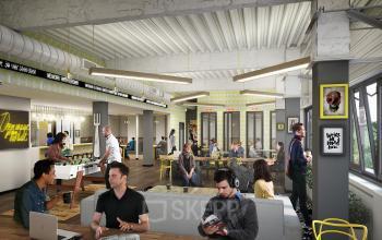 Bright and modern office space rental at Weteringschans 165, Amsterdam Center, with professionals engaged in collaborative work and discussions.