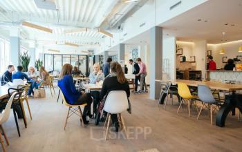 Professionals having a meeting in a stylish, bright office space rental at Weteringschans 165, Amsterdam Center, fostering collaboration.