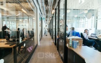 Modern office space rental at Weteringschans 165, Amsterdam Center, with employees engaged in business activities.