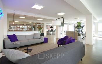 Modern office space with comfortable seating, bright lighting, and stylish decor at Kleine Gartmanplantsoen 21, ideal for office space rental in Amsterdam Center.