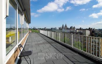 Spacious terrace with a view of Amsterdam's skyline, located at Kleine Gartmanplantsoen 21, perfect for taking a break from your office space rental.