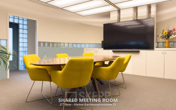 Bright meeting room with yellow chairs around a wooden table, located at Kleine Gartmanplantsoen 21, Amsterdam Center, perfect for office space rental.