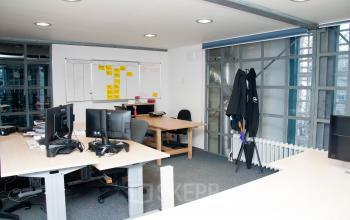 Modern office space at Zuiderkerkhof 72, Amsterdam Center, featuring desks with computers and a collaborative workspace, available for office space rental.