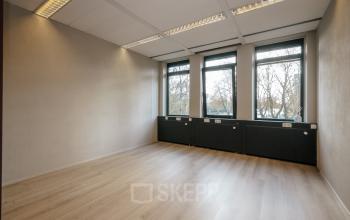 Empty office to rent with large windows allowing natural light at IJsbaanpad 2, Amsterdam De Schinkel, ideal for office space rental.