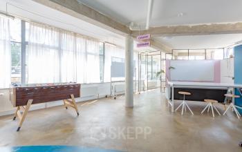 Bright office at Generaal Vetterstraat 77e, Amsterdam De Schinkel with open space, large windows, and a foosball table. Ideal for office space rental.