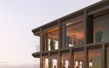 Modern office space rental at Rijnsburgstraat 9-11, Amsterdam De Schinkel, featuring large windows and interior lighting with people engaged in business activities.