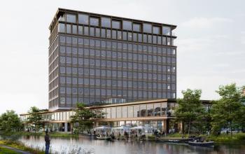 Exterior view of the office building located at Rijnsburgstraat 9-11 9-11, Amsterdam De Schinkel, Amsterdam, adjacent to a canal and surrounded by greenery.
