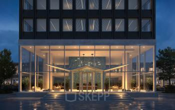 Exterior view of an office building at Rijnsburgstraat 9-11, Amsterdam De Schinkel, Amsterdam, featuring large glass windows and a well-lit entrance.