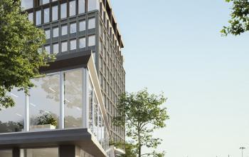 Exterior view of the office building at Rijnsburgstraat 9-11 9-11, Amsterdam De Schinkel, along a canal on a tree-lined pathway.