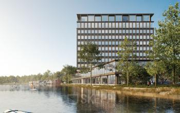 Exterior view of office building at Rijnsburgstraat 9-11, Amsterdam De Schinkel, with modern architecture next to a waterfront.