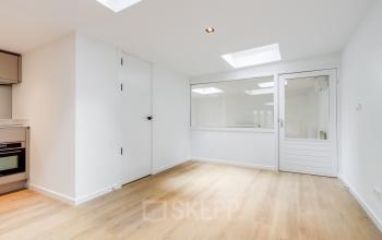 Bright office space available for rent at Schinkelkade 44, Amsterdam De Schinkel, featuring wooden flooring and large windows.