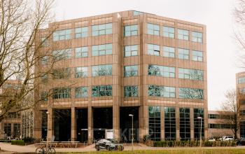 Exterior view of office building at Overschiestraat 182, Amsterdam De Schinkel, showcasing large windows and modern design, ideal for office space rental.