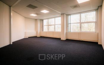 Spacious unfurnished office space available for rent at Overschiestraat 182, Amsterdam De Schinkel. Large windows offer ample natural light.