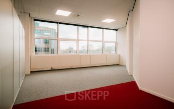 Unfurnished office space at Overschiestraat 182, offering natural light through large windows, ideal for office space rental in Amsterdam De Schinkel.