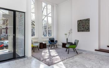 Bright office interior at Keizersgracht 62–64, Amsterdam Canal Belt, featuring modern chairs and natural light, ideal for office space rental.
