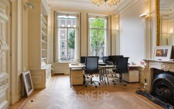 Bright office space with large windows, wooden parquet floor, and modern desks at Herengracht 282, Amsterdam Canal Belt, Amsterdam.