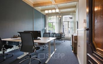 Elegant office space rental at Herengracht 282 with classic detailing and modern furniture, bright windows overlooking Amsterdam Canal Belt.