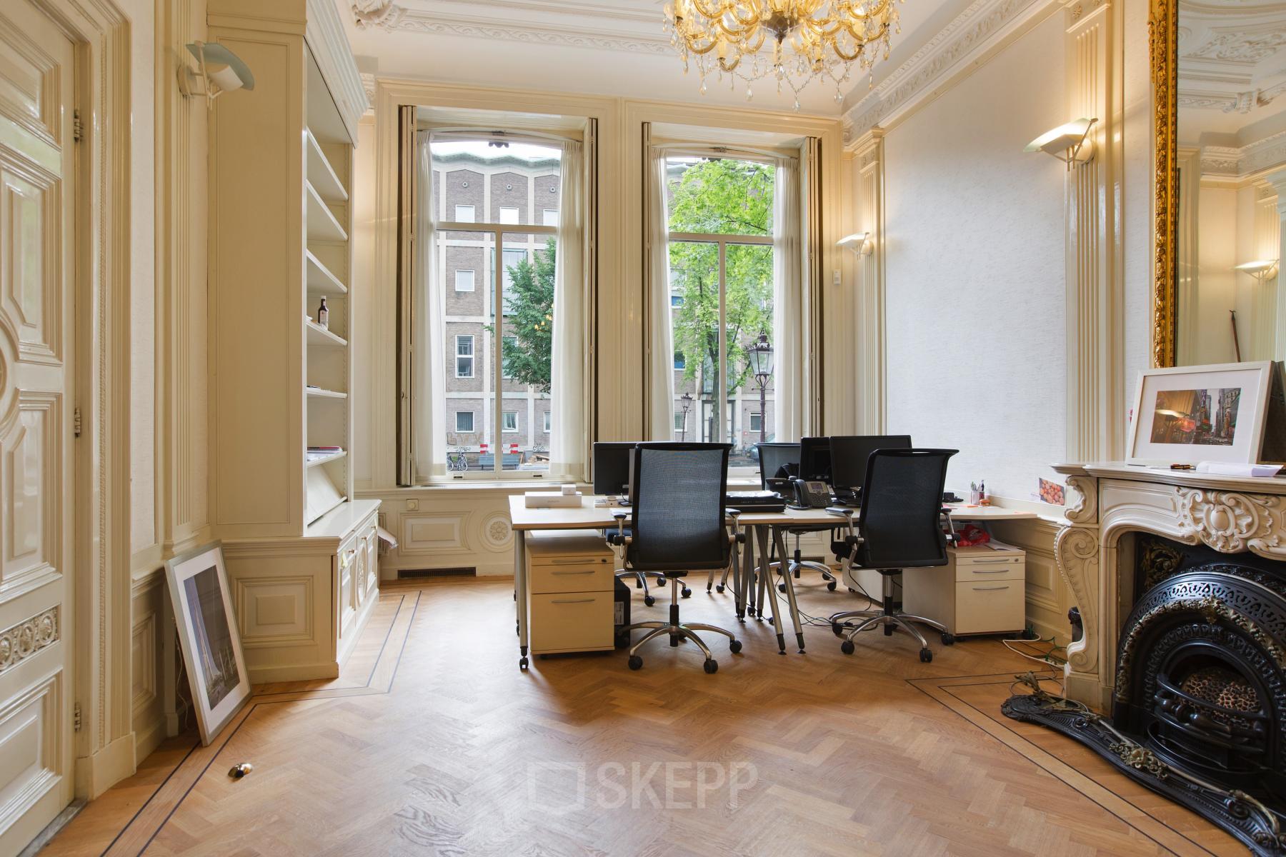 Bright office space with large windows, wooden parquet floor, and modern desks at Herengracht 282, Amsterdam Canal Belt, Amsterdam.