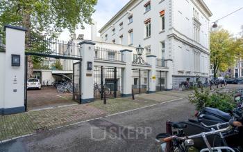 Exterior view of the office building located at Keizersgracht 452, in Amsterdam Canal Belt, Amsterdam, featuring a secure entrance gate, bicycle parking, and classic architecture.
