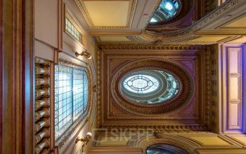 Grand ornate interior with detailed ceiling and large stained glass windows at office space rental location on Keizersgracht 452, Amsterdam Canal Belt.