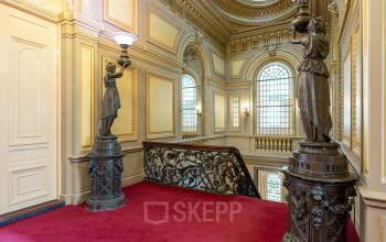 Elegant, classical entrance hall with ornate statues and a red carpet at Keizersgracht 452, Amsterdam Canal Belt, Amsterdam, ideal for office space rental.