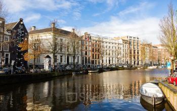A scenic view of the Amsterdam Canal Belt at Keizersgracht 452, showcasing historic buildings along the water.