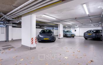 Underground parking area at Keizersgracht 452, Amsterdam Canal Belt, featuring multiple parked cars.