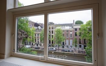 View of Amsterdam Canal Belt buildings from office window at Herengracht 448-458, Amsterdam, suitable for office space rental.