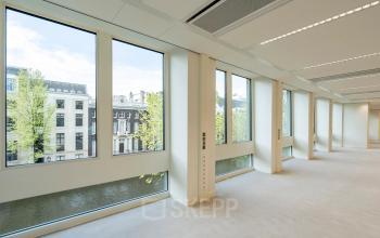 Interior view of an office space rental at Herengracht 459-469, featuring large windows and abundant natural light with canal views in Amsterdam Canal Belt.