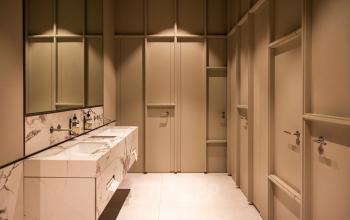 Stylishly designed restroom with modern sinks and elegant lighting, offering a clean and sophisticated ambiance in the Amsterdam Canal Belt.
