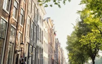 Exterior view of office buildings at Keizersgracht 97-99, Amsterdam Canal Belt, featuring historic architecture and scenic canal-side setting.