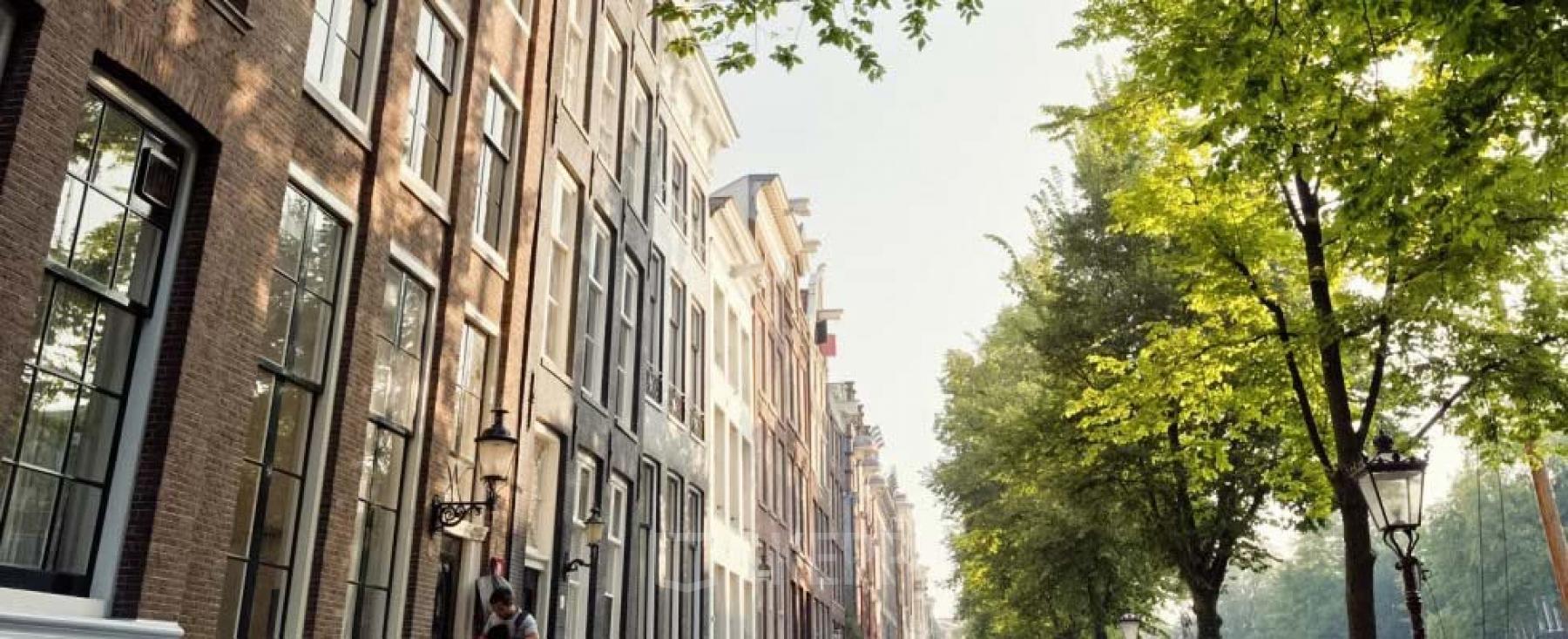 Exterior view of office buildings at Keizersgracht 97-99, Amsterdam Canal Belt, featuring historic architecture and scenic canal-side setting.