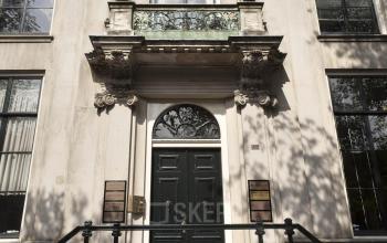 Exterior view of office building at Herengracht 495 in Amsterdam Canal Belt, Amsterdam. Elegant facade with detailed stonework and large windows.
