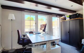 Office space with a desk, computer, and minimal furnishings at Keizersgracht 106 in Amsterdam Canal Belt.