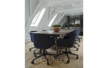 Charming attic conference room with a wooden table and modern chairs at Herengracht 168, Amsterdam Canal Belt, ideal for office space rental.