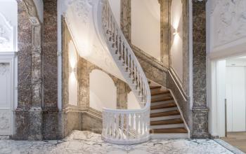Elegant staircase in the office space rental at Herengracht 168 in Amsterdam Canal Belt, with intricate design and marble details.