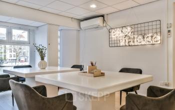 Modern, well-lit office space rental at Amstel 62, with large windows overlooking the Amsterdam Canal Belt.