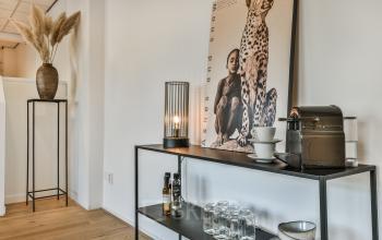 Chic office space rental at Amstel 62, Amsterdam Canal Belt with a sleek sideboard, coffee machine, and stylish decor.