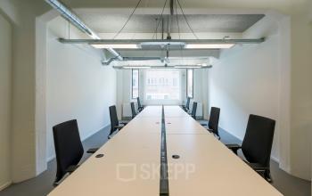 Bright and spacious office to rent at Van Diemenstraat 20-200, Amsterdam Houthavens, featuring a long table with ergonomic chairs, ideal for collaborative work. Natural light enhances the modern design.