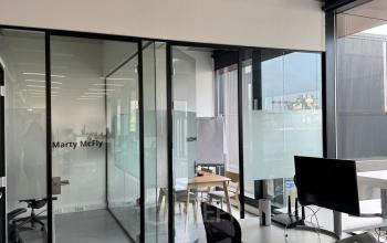 Modern furnished office space with glass partitions at Moermanskkade 303, ideal for office space rental in Amsterdam Houthavens.