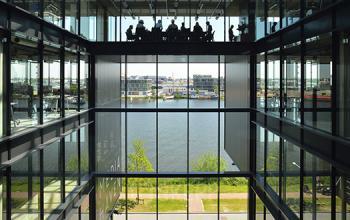 Interior view of an office building at Archangelkade 9, Amsterdam Houthavens, with large windows and a clear view of the canal.