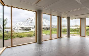 Bright office space in Amsterdam IJburg with large windows offering scenic views of the surrounding area, perfect for businesses seeking office space rental.