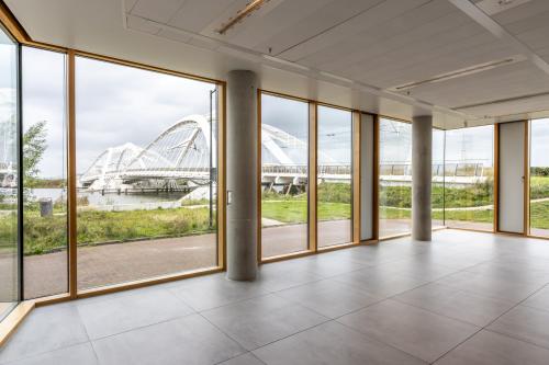 Bright office space in Amsterdam IJburg with large windows offering scenic views of the surrounding area, perfect for businesses seeking office space rental.