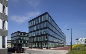 Modern office building with large glass windows at Pedro de Medinalaan 7, ideal for those looking to rent office space in Amsterdam IJburg.