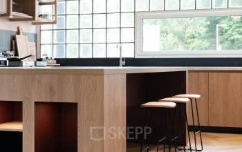 Chic office space rental at Overschiestraat 65, Amsterdam New-West, featuring a modern pantry with stylish wooden furnishings and ample natural light.