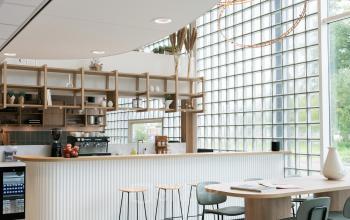 Contemporary office space rental at Overschiestraat 65, Amsterdam New-West, featuring a stylish pantry and seating area.