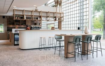 Modern office space rental at Overschiestraat 65, Amsterdam Nieuw-West, featuring a stylish pantry with seating area.
