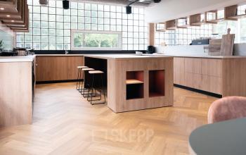 Modern office space rental at Overschiestraat 65, Amsterdam Nieuw-West with a stylish kitchenette and seating area.