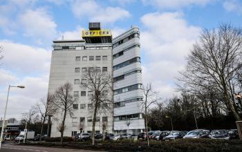 Exterior of office building located at Overschiestraat 63, Amsterdam New-West, Amsterdam, with ample parking space in front.
