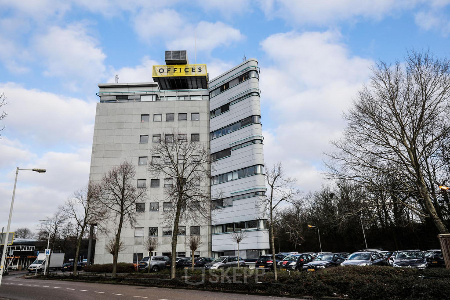 Exterior of office building located at Overschiestraat 63, Amsterdam New-West, Amsterdam, with ample parking space in front.